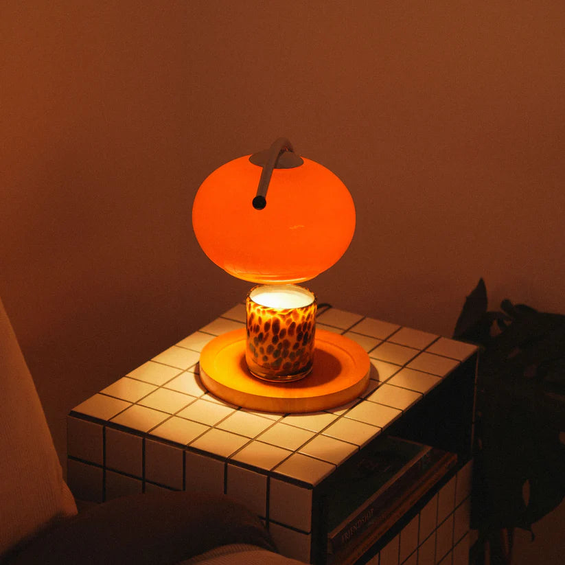 The Solange - Lucy’s Lamps is a modern orange glass table lamp with candle warmer lamp functionality. Aesthetic retro stained glass lamp ideal as a bedside table lamp, small desk lamp, or minimalist side table lamp. Perfect for bedroom table lamps or modern lamp for living room styling.