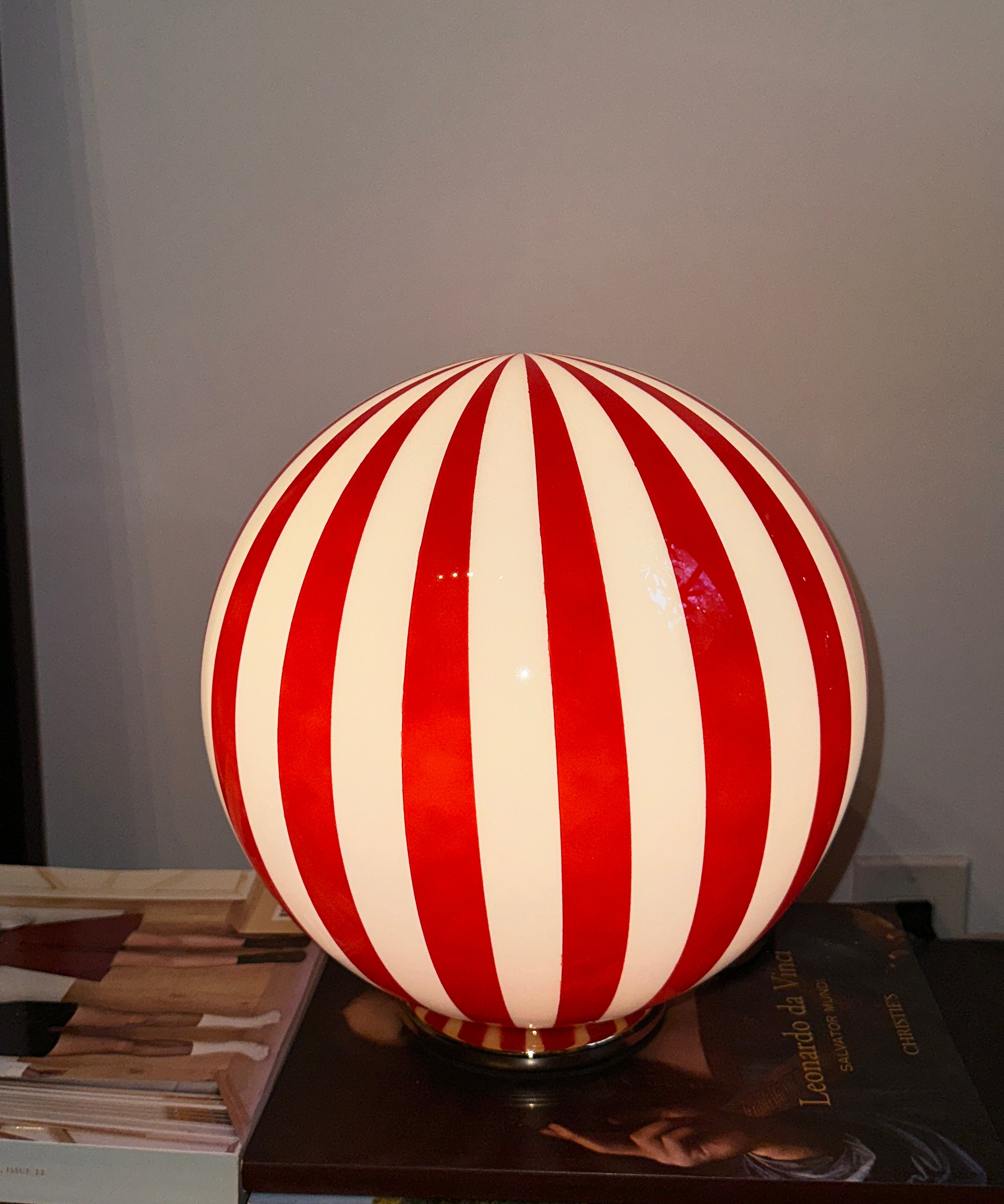 Luca - Lucy’s Lamps is a bold red and white striped globe table lamp with a retro vibe. Perfect as a modern table lamp, aesthetic desk lamp, or bedside lamp. Ideal for vintage light fixtures, retro lamps, table lamps for bedroom, and modern lamp for living room setups.