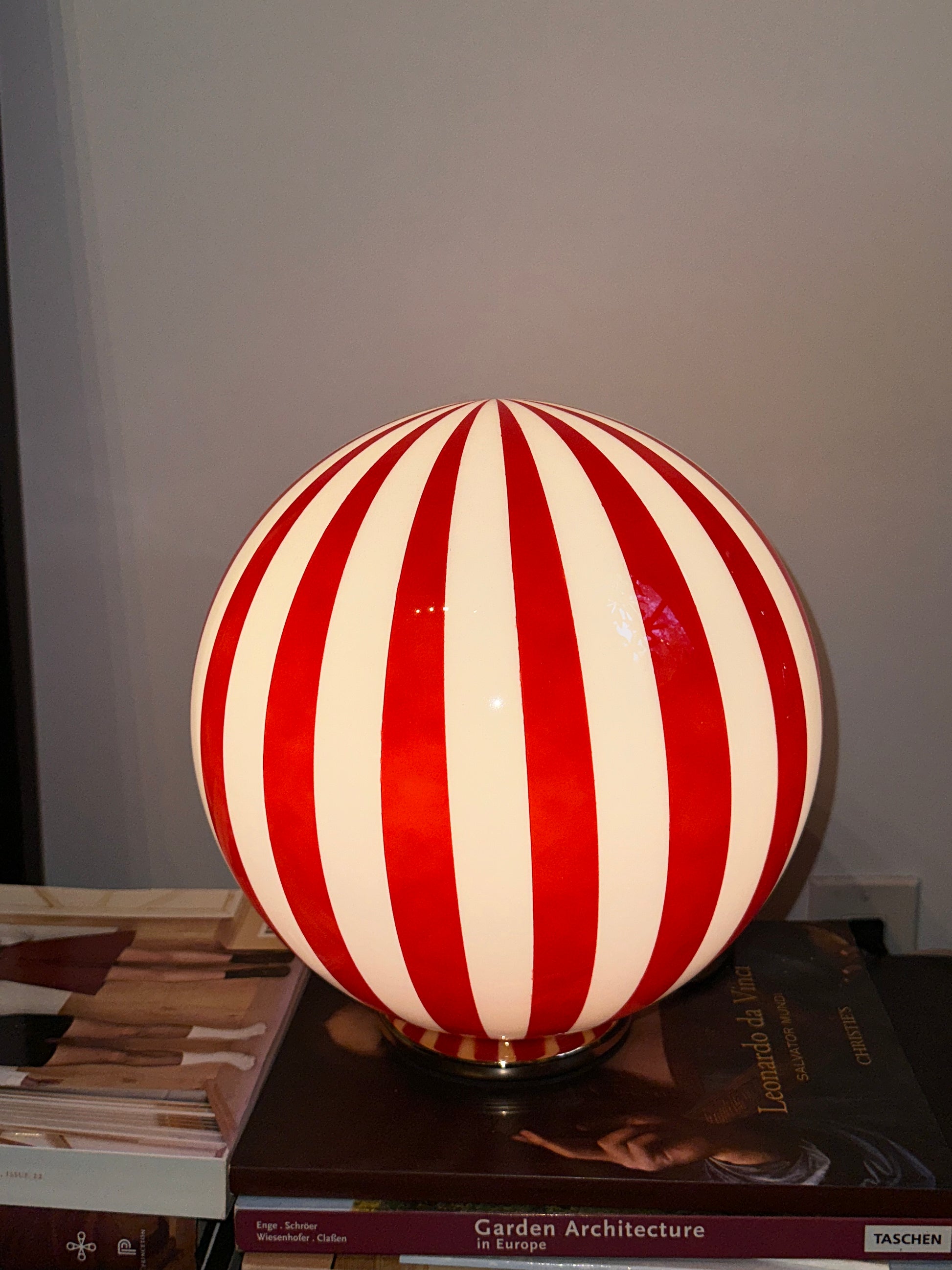 Luca - Lucy’s Lamps is a bold red and white striped globe table lamp with a retro vibe. Perfect as a modern table lamp, aesthetic desk lamp, or bedside lamp. Ideal for vintage light fixtures, retro lamps, table lamps for bedroom, and modern lamp for living room setups.