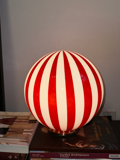 Luca - Lucy’s Lamps is a bold red and white striped globe table lamp with a retro vibe. Perfect as a modern table lamp, aesthetic desk lamp, or bedside lamp. Ideal for vintage light fixtures, retro lamps, table lamps for bedroom, and modern lamp for living room setups.