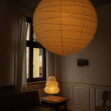 The Akari Boru - Lucy’s Lamps is a minimalist paper lantern pendant lamp inspired by traditional Japanese design. This aesthetic lamp adds a warm, soft glow to any room, perfect for living rooms, bedrooms, or reading spaces. Combining modern designer lighting with vintage charm, The Akari Boru creates a cozy, timeless ambiance ideal for both modern and retro interiors.