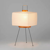 The Akari Shikaku - Lucy’s Lamps is a modern paper lantern floor lamp inspired by Japanese artistry. This minimalist lamp features a tripod base and soft diffused light, perfect for bedrooms, living rooms, or corners. Combining modern designer lighting with vintage elegance, this aesthetic lamp enhances any home as a cozy bedside lamp or stylish modern floor lamp.