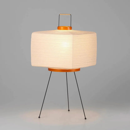 The Akari Shikaku - Lucy’s Lamps is a modern paper lantern floor lamp inspired by Japanese artistry. This minimalist lamp features a tripod base and soft diffused light, perfect for bedrooms, living rooms, or corners. Combining modern designer lighting with vintage elegance, this aesthetic lamp enhances any home as a cozy bedside lamp or stylish modern floor lamp.
