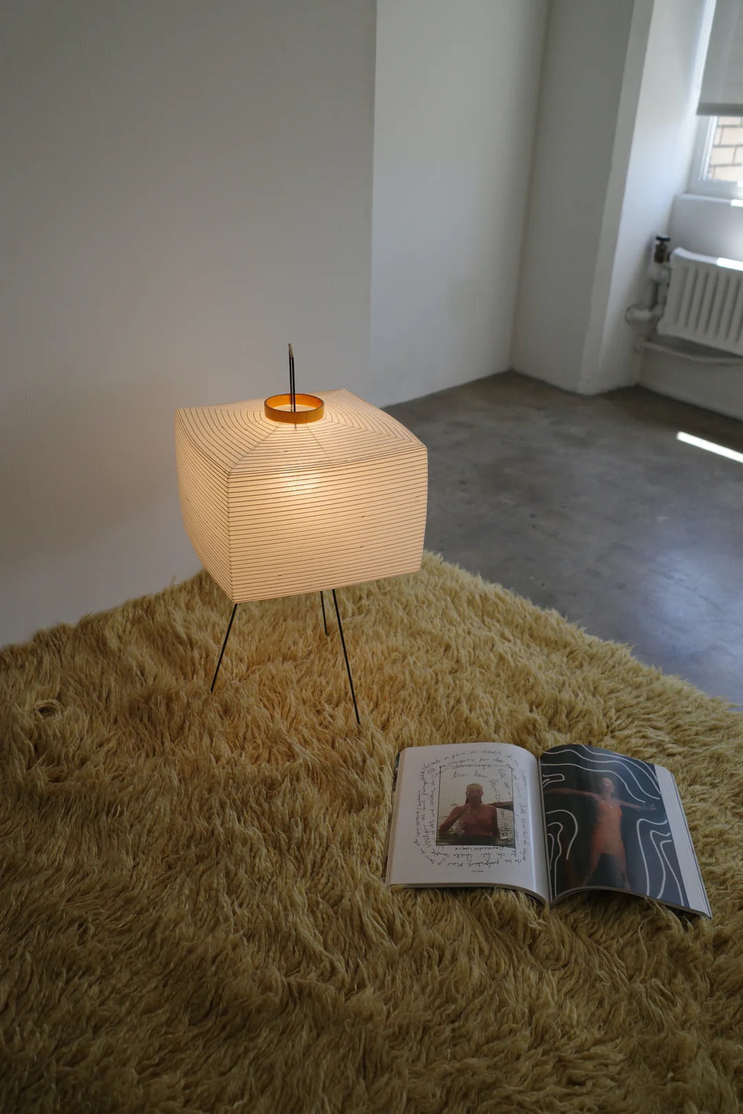 The Akari Shikaku - Lucy’s Lamps is a modern paper lantern floor lamp inspired by Japanese artistry. This minimalist lamp features a tripod base and soft diffused light, perfect for bedrooms, living rooms, or corners. Combining modern designer lighting with vintage elegance, this aesthetic lamp enhances any home as a cozy bedside lamp or stylish modern floor lamp.