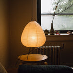 The Akari Suiteki - Lucy’s Lamps is a minimalist paper lantern table lamp inspired by Japanese design. This aesthetic and modern table lamp adds a warm glow to bedrooms, living rooms, or workspaces. Perfect as a bedside lamp, side table lamp, or desk lamp, it blends retro charm and modern designer lighting for elegant, timeless home décor.