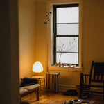 The Akari Suiteki - Lucy’s Lamps is a minimalist paper lantern table lamp inspired by Japanese design. This aesthetic and modern table lamp adds a warm glow to bedrooms, living rooms, or workspaces. Perfect as a bedside lamp, side table lamp, or desk lamp, it blends retro charm and modern designer lighting for elegant, timeless home décor.