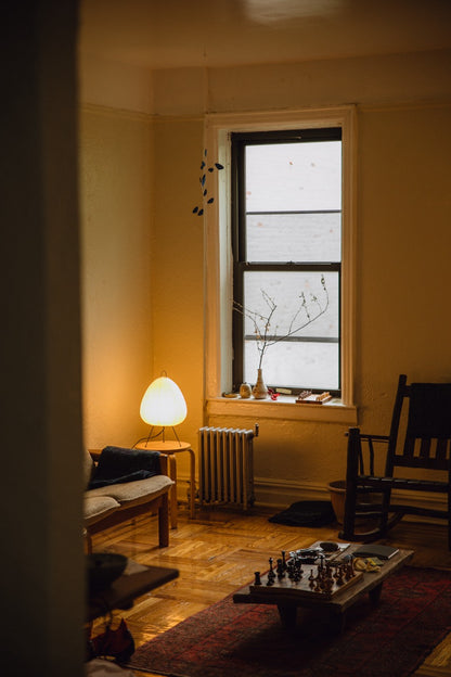 The Akari Suiteki - Lucy’s Lamps is a minimalist paper lantern table lamp inspired by Japanese design. This aesthetic and modern table lamp adds a warm glow to bedrooms, living rooms, or workspaces. Perfect as a bedside lamp, side table lamp, or desk lamp, it blends retro charm and modern designer lighting for elegant, timeless home décor.