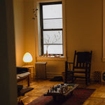 The Akari Suiteki - Lucy’s Lamps is a minimalist paper lantern table lamp inspired by Japanese design. This aesthetic and modern table lamp adds a warm glow to bedrooms, living rooms, or workspaces. Perfect as a bedside lamp, side table lamp, or desk lamp, it blends retro charm and modern designer lighting for elegant, timeless home décor.