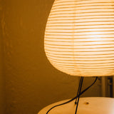 The Akari Suiteki - Lucy’s Lamps is a minimalist paper lantern table lamp inspired by Japanese design. This aesthetic and modern table lamp adds a warm glow to bedrooms, living rooms, or workspaces. Perfect as a bedside lamp, side table lamp, or desk lamp, it blends retro charm and modern designer lighting for elegant, timeless home décor.