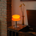 The Capella - Lucy’s Lamps retro stained glass orange table lamp serves as a modern table lamp for bedroom or living room. This small desk lamp is perfect as a bedside table lamp, side table lamp, light therapy lamp, and aesthetic lamp for minimalist spaces. Explore Lucys Lamps for more home lighting ideas.