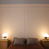 The Chroma - Lucy’s Lamps is a minimalist matte white table lamp with a modern mushroom silhouette. Perfect as a bedside lamp, side table lamp, or aesthetic desk lamp. This retro table lamp fits well in modern lamp for bedroom, small desk lamp setups, or living room table lamps.