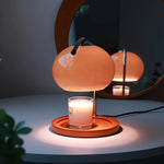 The Solange - Lucy’s Lamps is a modern orange glass table lamp with candle warmer lamp functionality. Aesthetic retro stained glass lamp ideal as a bedside table lamp, small desk lamp, or minimalist side table lamp. Perfect for bedroom table lamps or modern lamp for living room styling. Explore Lucys Lamps for more home lighting ideas.